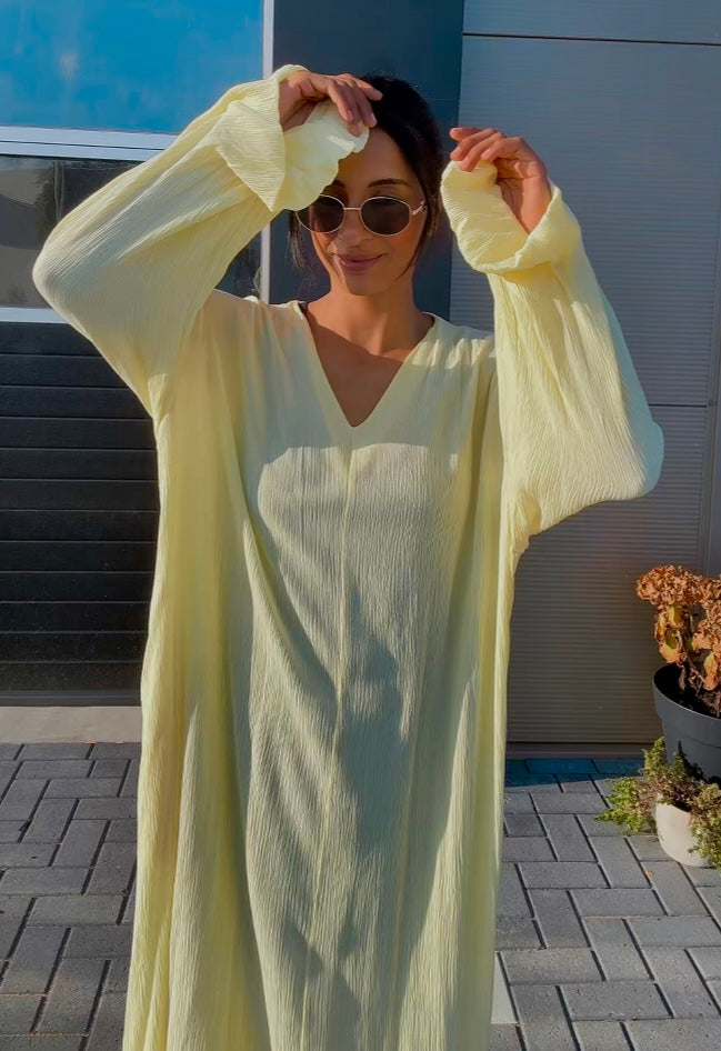 Lange jurk met zakken en franje mouwen - butter yellow